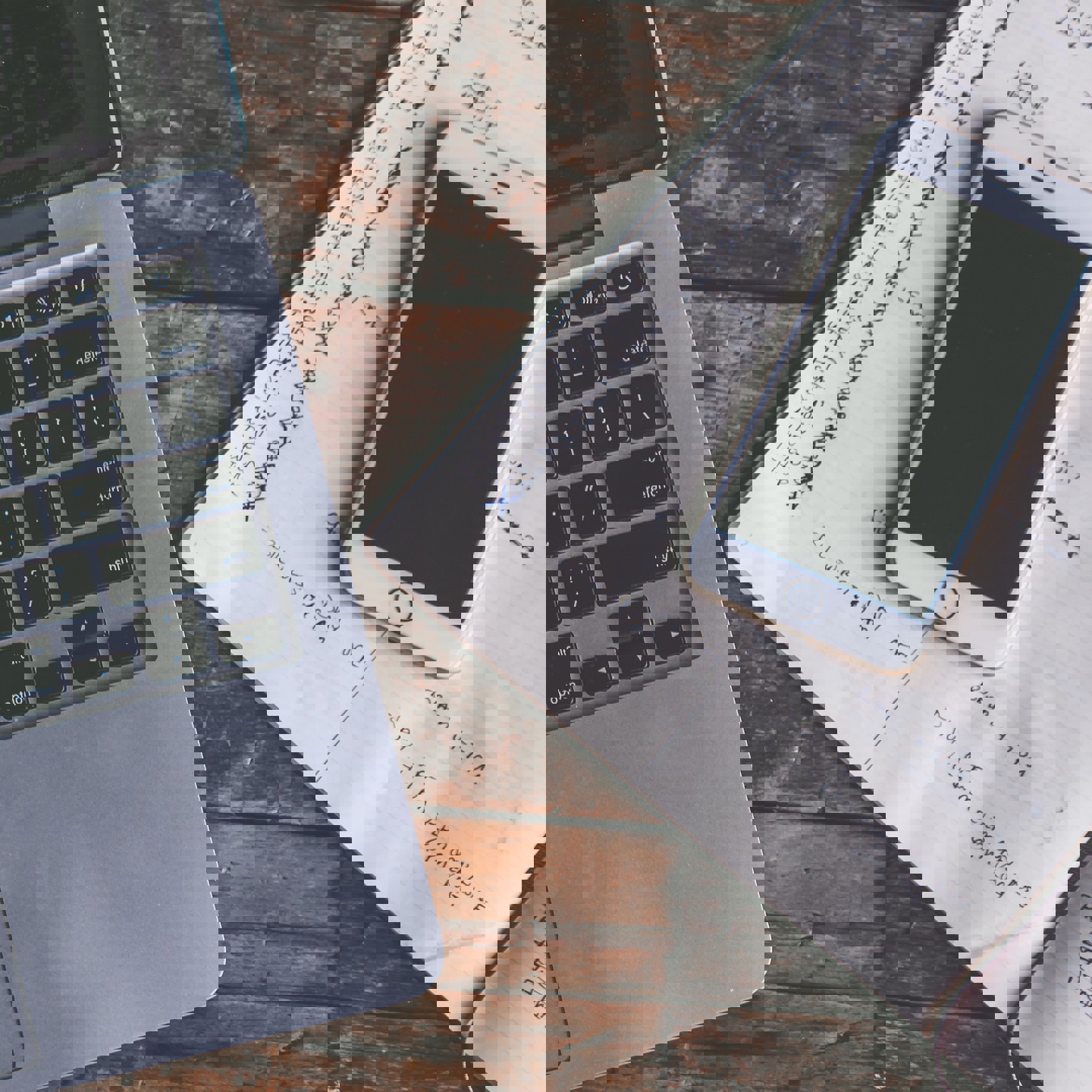 Laptop, phone and notebook on a desk