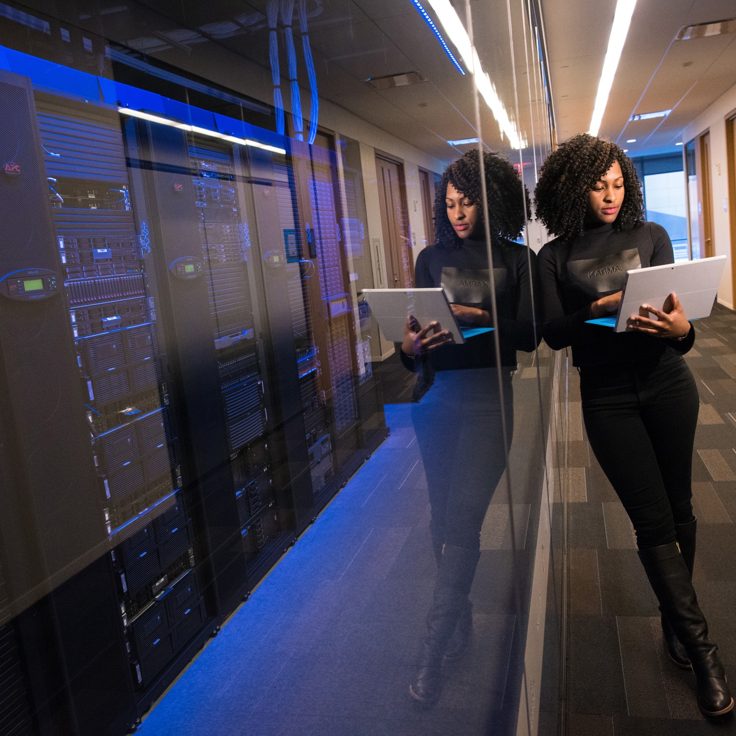 Women viewing laptop in front of serverbanks