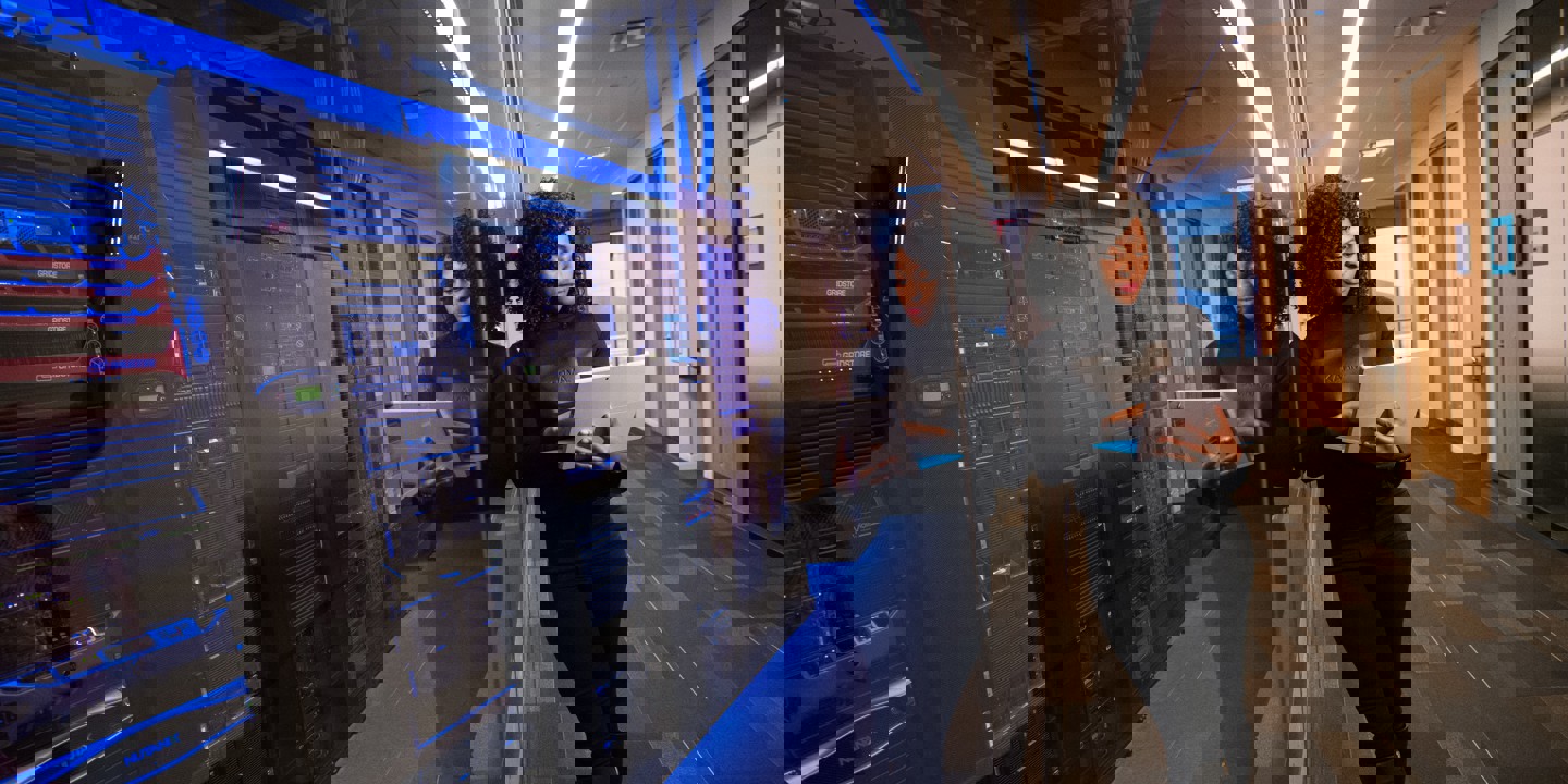 Women viewing laptop in front of serverbanks